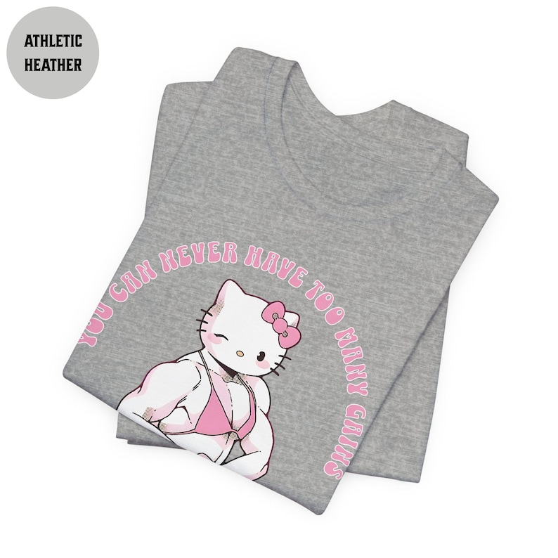 May include: A gray t-shirt with a pink Hello Kitty graphic. The graphic shows Hello Kitty with large muscles and the text "You can never have too many gains".