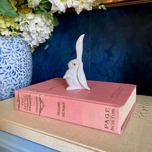 May include: A set of three ceramic mugs with a speckled, matte finish. The mugs are in shades of cream, light gray, and dark gray. Each mug has a simple, minimalist design, perfect for coffee or tea.