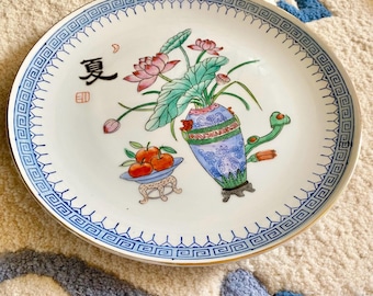 10.25” Chinese Porcelain Plate w/ Hand-Painted Lotus Vase, Fruit, & Calligraphy – Blue Greek Key Border, Red Mark, Chinoiserie Wall Decor