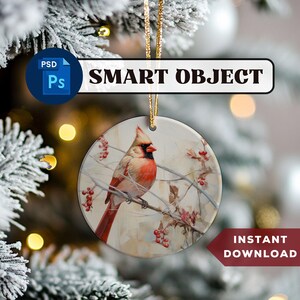 May include: A round, white Christmas bauble featuring a red cardinal perched on a branch with red berries. The bauble has a rustic, vintage appearance.