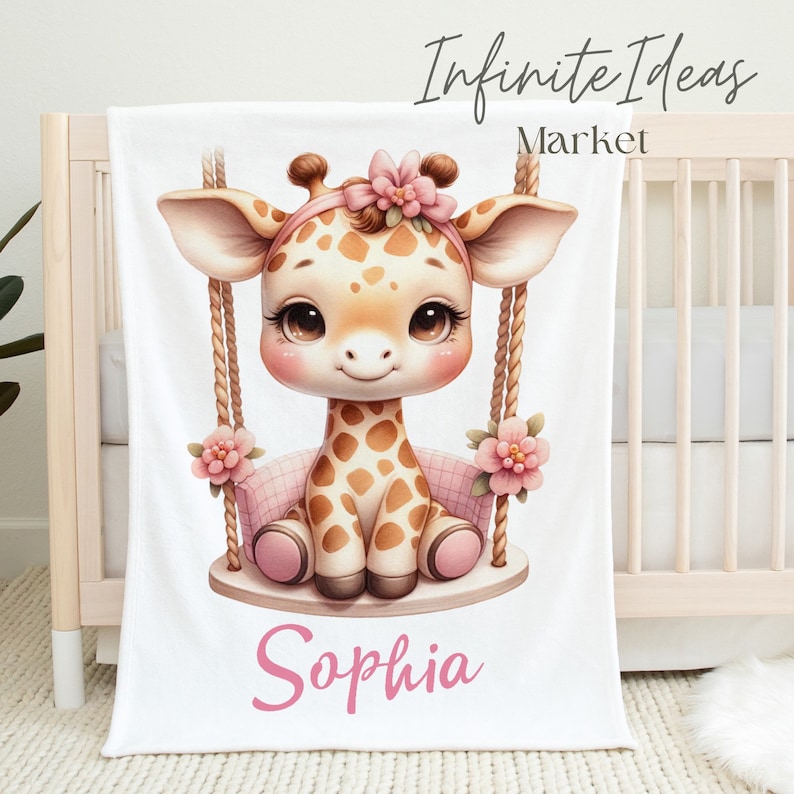May include: A white baby blanket with a cute cartoon giraffe on a swing. The giraffe is brown and white with pink flowers and a pink bow. The blanket is personalized with the name "Sophia" in pink.