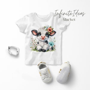 May include: White t-shirt featuring a cartoon illustration of a black and white calf wearing a flower crown. The calf is surrounded by flowers in shades of pink, blue, and white. The text "Infinite Ideas Market" is in the top right corner of the image.