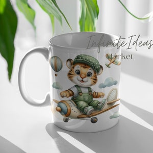 May include: White ceramic mug with a cartoon tiger wearing a green and white outfit and a blue hat, flying a small airplane. The mug has the text "Infinite Ideas Market" on it.