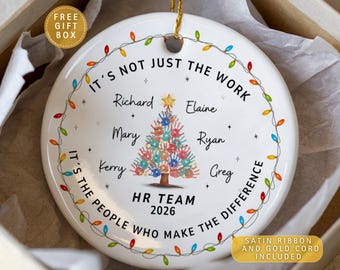 May include: A round white ceramic ornament featuring a central Christmas tree made of colorful handprints. The text reads IT'S NOT JUST THE WORK IT'S THE PEOPLE WHO MAKE THE DIFFERENCE, HR TEAM 2026, and names Richard, Elaine, Mary, Ryan, Kerry, Greg.