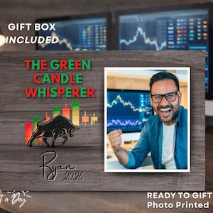 May include: A wooden photo frame with the text "THE GREEN CANDLE WHISPERER" in green and red. The frame includes a photo of a man smiling and a bull graphic. The text "Ryan 2026" is also present.