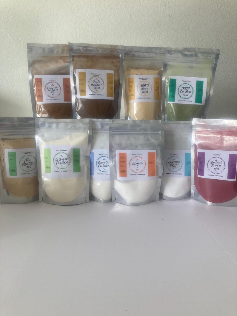 May include: A collection of clear, resealable pouches filled with various powders. Each pouch has a label with text such as "Collagen Peptides" and "Vitamin C". The powders are in shades of beige, white, and red.