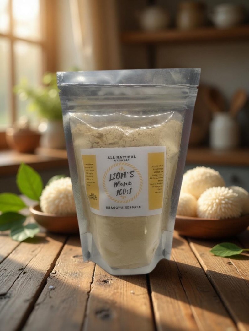 May include: A clear, resealable pouch filled with light brown powder, labeled "Lion's Mane 100:1" and "All Natural Organic." The pouch sits on a wooden surface with wooden bowls containing white, spherical objects. The background features a kitchen setting.
