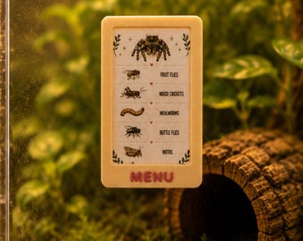 May include: A rectangular beige sign with the word MENU in pink letters, featuring a list of insect food items including fruit flies, house crickets, mealworms, bottle flies, and moths, with a small spider illustration at the top.