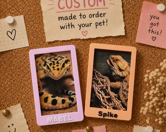 May include: Two rectangular frames with photos of reptiles. The left frame is light purple with the name MABEL in white letters. The right frame is peach with the name Spike in black letters. Above them is a note reading CUSTOM made to order with your pet!