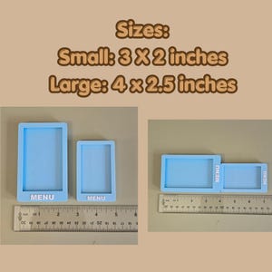 May include: Two light blue rectangular silicone molds with the word MENU embossed in white. The small mold measures 3 by 2 inches and the large mold measures 4 by 2.5 inches, as shown by the visible metal ruler in the image.