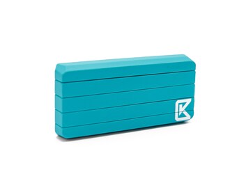 May include: A teal blue rectangular box with a white letter "K" logo on the side.