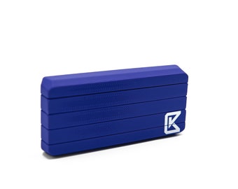 May include: A blue rectangular object with a textured surface and a white logo. The object appears to be made of a solid material and has a geometric design. The logo is a stylized letter "K".