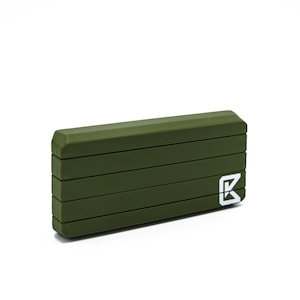 May include: A dark green rectangular box with a white letter "K" logo. The box has a textured surface and appears to be made of a durable material.