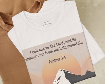 May include: White t-shirt with a graphic design of a mountain range with a sunset behind it. The text "I call out to the Lord, and He answers me from His holy mountain. Psalms 3:4" is printed on the shirt.