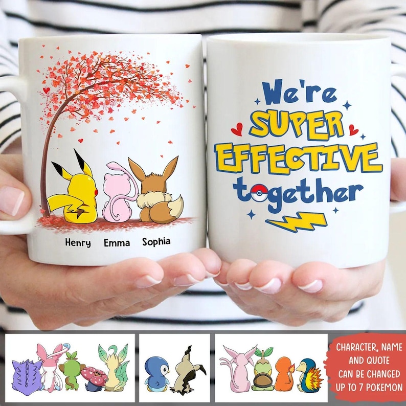 May include: Two white ceramic mugs with cartoon characters and text. One mug features a tree with red leaves and three characters with the names "Henry", "Emma", and "Sophia". The other mug says "We're SUPER EFFECTIVE together".
