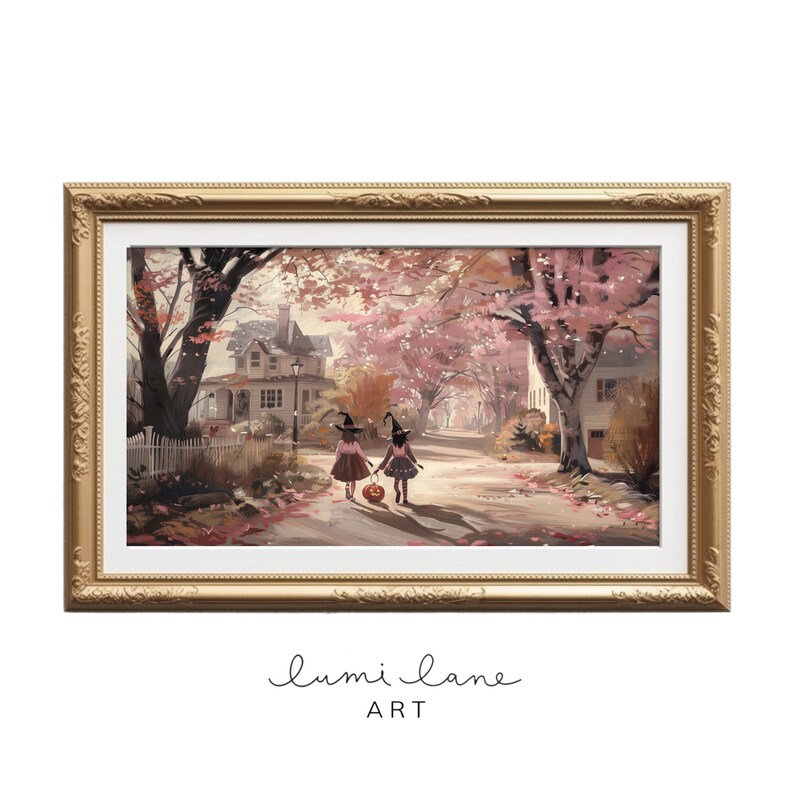May include: Two young girls dressed as witches walk down a path lined with trees in autumn. They are carrying a jack-o-lantern and wearing pink dresses and black witch hats. The path is covered in fallen leaves and the trees are in shades of pink and orange.