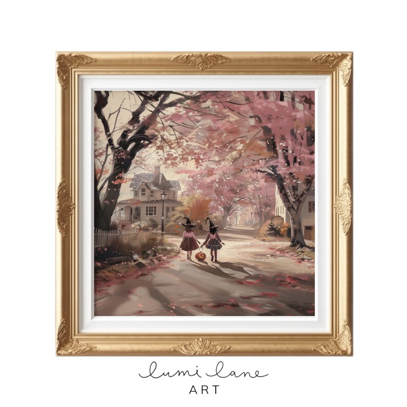 May include: Two children dressed as witches walk down a street lined with pink trees. They are carrying a pumpkin and are dressed in pink and black. The street is lined with houses and there are fall leaves on the ground.