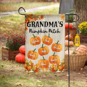 May include: A rectangular garden flag featuring a white wood-plank background with the text Grandma's Pumpkin Patch at the top. Seven orange pumpkins are illustrated, each labeled with a name: Sophia, Jack, Selina, Mike, Anna, Susan, and John.