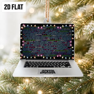May include: A flat, 2D laptop-shaped Christmas ornament featuring a screen displaying lines of computer code surrounded by a border of colorful holiday lights. The silver-colored base includes a trackpad with the name JACKSON printed on it.