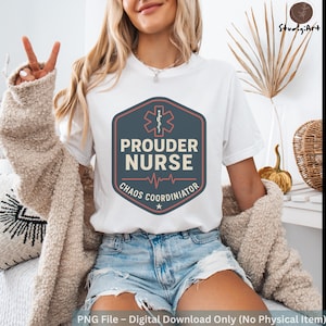 May include: White t-shirt with a navy blue and red graphic that reads "PROUDER NURSE CHAOS COORDINATOR". The design includes a medical symbol, a heartbeat line, and a star. The shirt is worn with denim shorts.