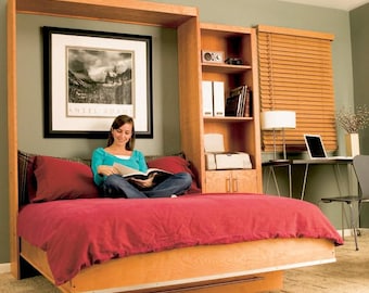 May include: A wooden wall bed with a red duvet and pillows. A woman is sitting on the bed reading a book. The bed is in a room with a bookshelf and a desk with a laptop.