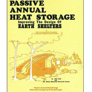 May include: A yellow and orange illustration of a passive annual heat storage earth shelter. The illustration shows a house built into a hillside with trees and a caption that reads "Passive Annual Heat Storage takes solar energy out of the dark ages."