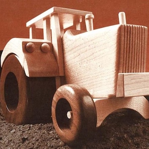 May include: A wooden toy tractor with a brown body and wheels. The tractor has a detailed design with a grill and a cab.