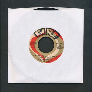 May include: A vintage 45 RPM vinyl record in a white paper sleeve. The record label is red, tan, and black, with the text "FIRE RECORDS" and the song title "I NEED YOUR LOVING" by Don Gardner and Dee Dee Ford.