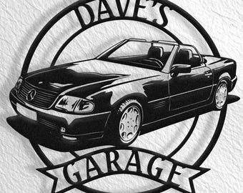 May include: Black and white metal silhouette of a convertible car with the text "Dave's Garage" in a circle around it.