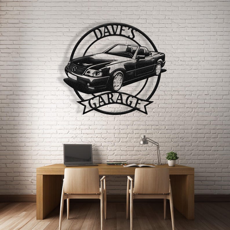 Op de afbeelding: Zwarte metalen wandkunst met een auto-silhouet en de tekst "Dave's Garage". De kunst is gemonteerd op een witte bakstenen muur.