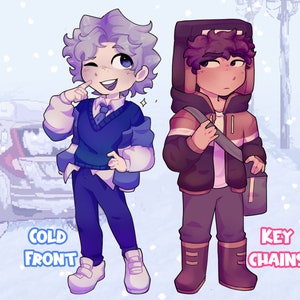 May include: Two cartoon characters, one with blue hair and a blue sweater, the other with brown hair and a brown jacket, standing in a snowy scene. The text "COLD FRONT" is below the blue-haired character and "KEY CHAINS" is below the brown-haired character.