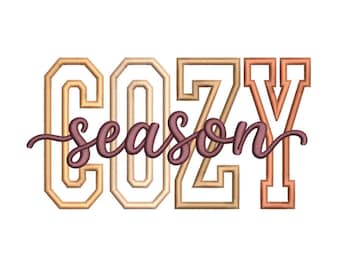 May include: An embroidery design featuring the word COZY in large, block-style letters with a gradient of tan, beige, and orange tones. The word season is written in a dark brown, cursive script that overlays the centre of the block letters.