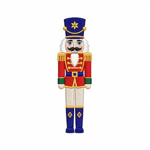 May include: An embroidered nutcracker patch featuring a blue hat with a gold star, a red jacket with gold trim and green cuffs, white trousers, and blue boots. The figure has a white beard, a black mustache, and blue eyes on a white background.