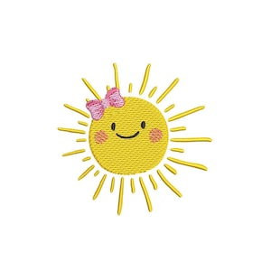 May include: Embroidered yellow sun with a smiling face, rosy cheeks, and a pink bow. The sun has yellow rays extending outwards. The design is on a white background.