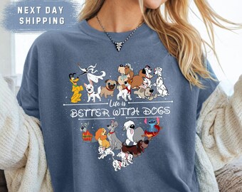 May include: A blue t-shirt with a heart-shaped design featuring various Disney dog characters. The text "Life is Better With Dogs" is printed below the heart.