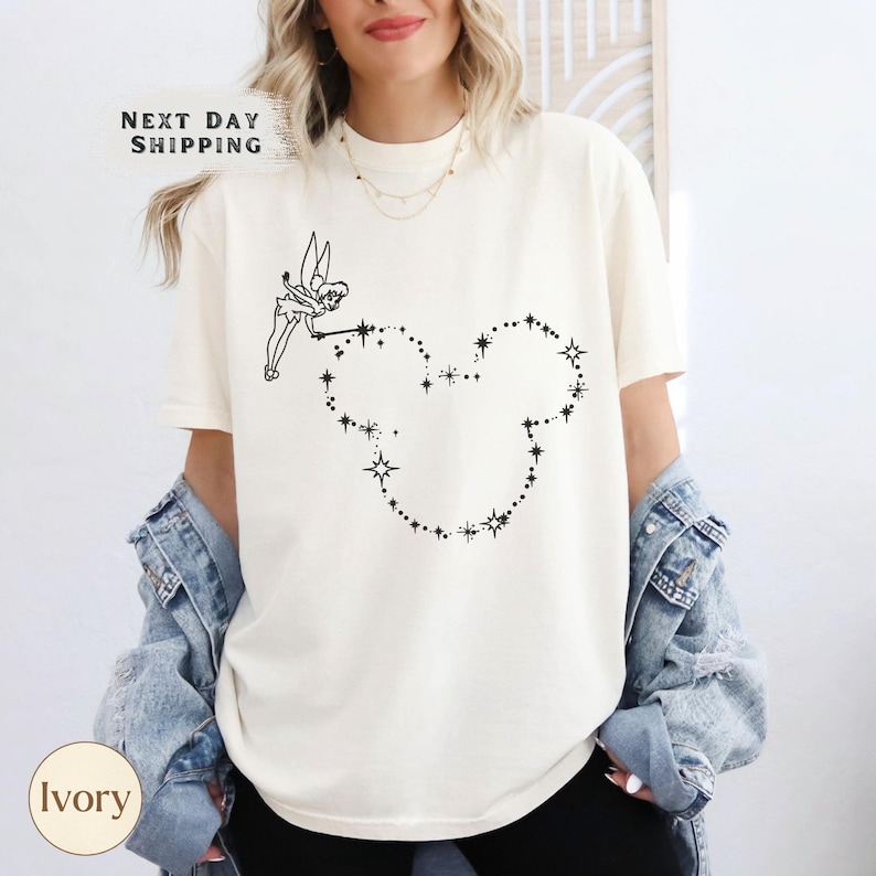 a woman wearing a mickey mouse t - shirt