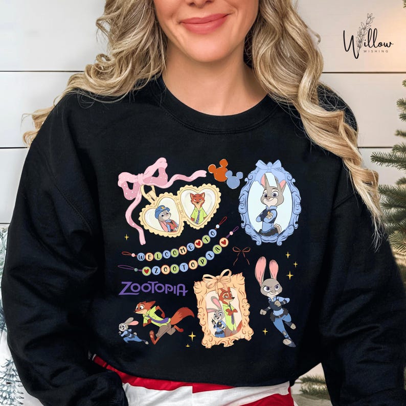 A woman wearing a black sweatshirt with various cartoon animal characters and a pink bow on it.