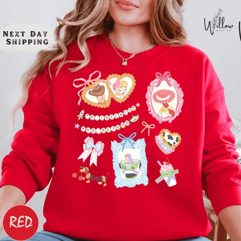 A woman wearing a red sweater with various cartoon-style illustrations and text on it.