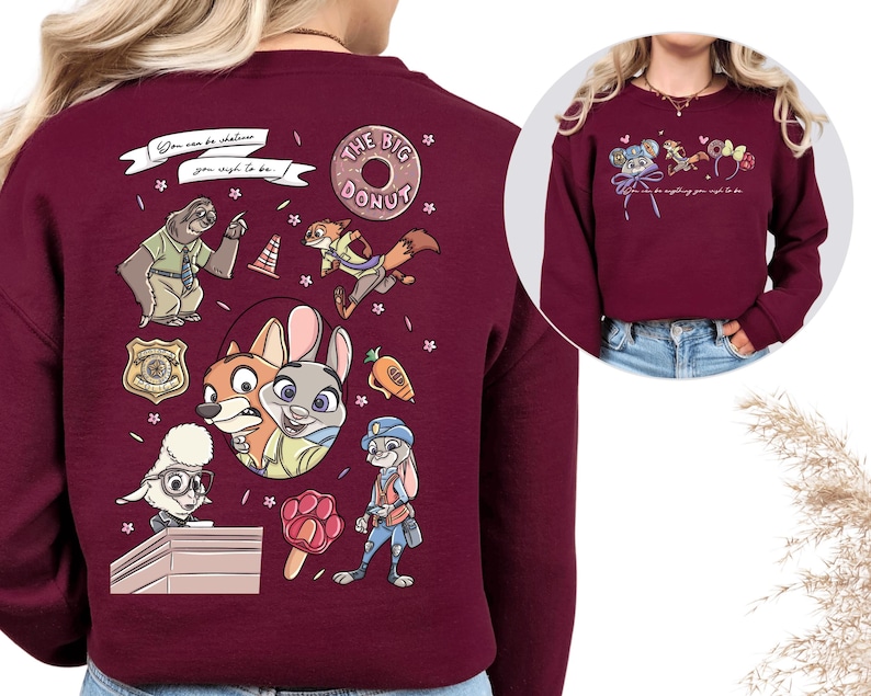a maroon sweatshirt with a variety of cartoon animal characters, including a police officer, a police dog, and other animals, along with various objects and text.