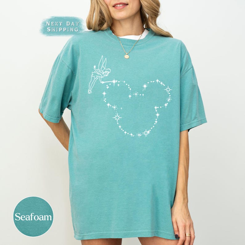 a woman wearing a blue shirt with a heart on it