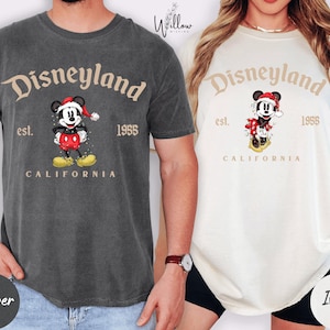 two t-shirts with Disneyland branding, one gray and one white, both with Mickey Mouse as the central character.