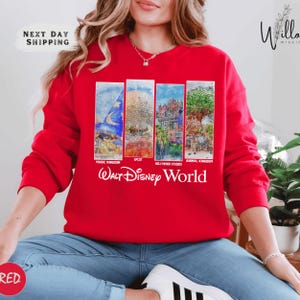 A woman wearing a red sweatshirt with a collage of four Disney-themed images, including a castle, a tropical island, a palace, and a character, along with the text "Walt Disney World".