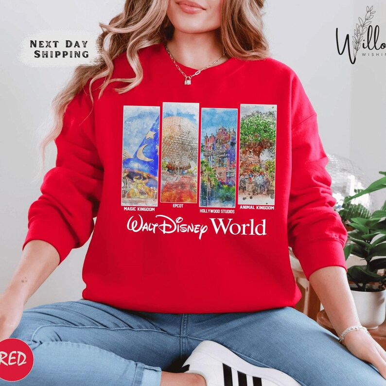 A woman wearing a red sweatshirt with a collage of four Disney-themed images, including a castle, a tropical island, a palace, and a character, along with the text "Walt Disney World".