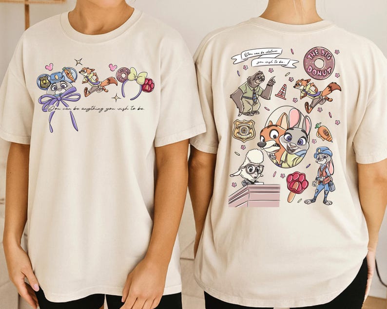 two white t-shirts with colorful cartoon characters and text printed on them.