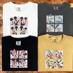 four t-shirts featuring cartoon characters from Disney's Mickey Mouse and Goofy.