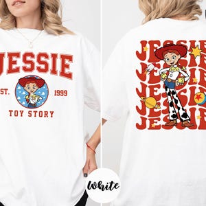 A white t-shirt with a design featuring a character from the Toy Story franchise, specifically the character named Jessie.