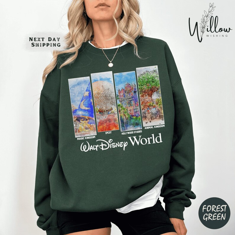 A woman wearing a green sweatshirt with a collage of four Disney World images on it.