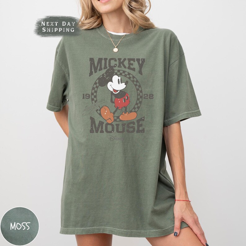 a woman wearing a mickey mouse t - shirt