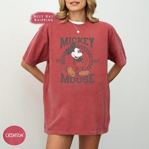 a woman wearing a mickey mouse t - shirt