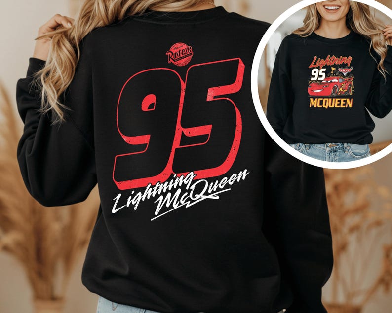 A person wearing a black sweatshirt with a large number 95 and the text "Lightning McQueen" printed on it.